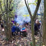 Forest school gathered by the fire