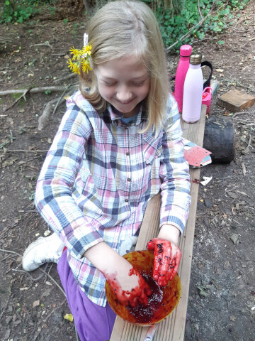 girl making blackberry mush